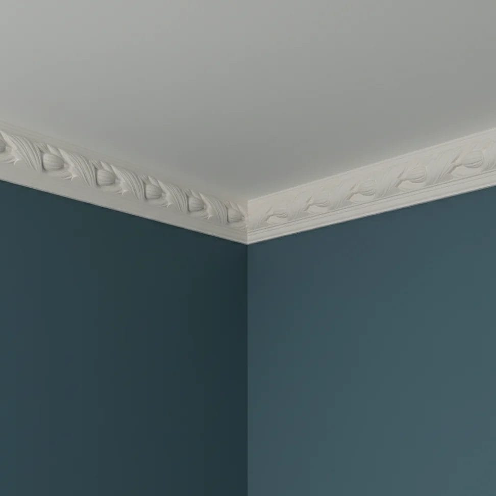 Decorative white molding showcasing intricate carvings, with a curved end piece and a straight section featuring repeating floral patterns. Its Called White PU Cornice Dado Rail